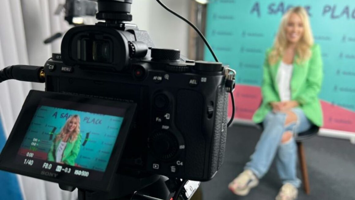 A founder is sitting recording video content for her business.