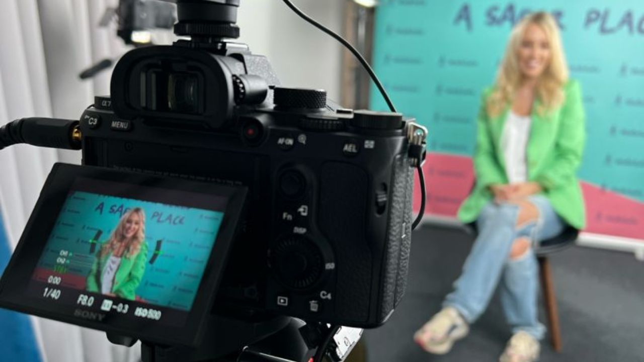 A founder is sitting recording video content for her business.